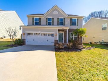 Charming two-story home featuring a two-car garage, well-maintained lawn and complementary landscaping at 3628 Benseval Ln, Matthews, NC 28104