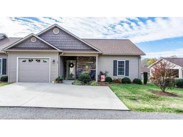 Charming home exterior featuring a stone accent wall, inviting front porch, and an attached garage at 505 2Nd Street Ne Pl # G-3, Conover, NC 28613