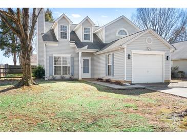 Charming two-story home with gray siding, a one-car garage, and a well-maintained front lawn at 11132 White Stag Dr, Charlotte, NC 28269