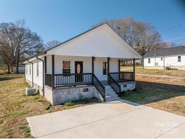 Charming home featuring a inviting front porch with black railings, perfect for enjoying the outdoors at 1411 Roseland Dr, Lincolnton, NC 28092