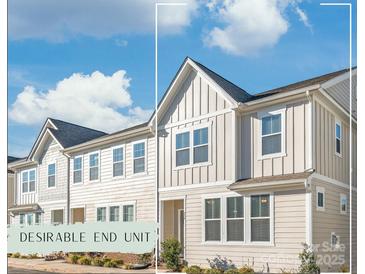 Charming end-unit townhouse with modern siding, bright windows, and well-manicured landscaping at 554 Amalfi Dr, Davidson, NC 28036