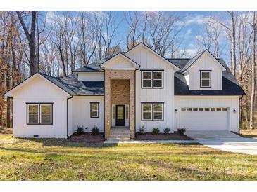 Beautiful two-story home with white siding, brick accents, and a well-manicured front yard at 606 Saint Cloud Dr, Statesville, NC 28625