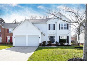 Charming two-story home with a well-manicured lawn and a two-car garage at 6420 Tunston Ln, Charlotte, NC 28269