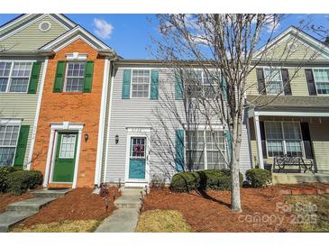 Charming townhouse with colorful shutters, a welcoming front door, and well-maintained landscaping at 6738 Rothchild Dr, Charlotte, NC 28270