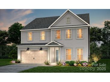 Charming two-story home featuring a symmetrical facade, neutral siding, and an attached two-car garage at 9512 Coast Laurel Nw Ave # 42, Concord, NC 28027
