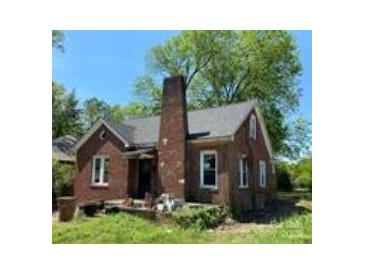Charming brick home featuring a prominent chimney and inviting front porch, perfect for relaxing outdoors at 107 Lineberger St # 6, Shelby, NC 28150