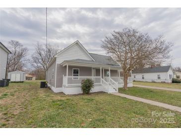 Charming single-story home with a covered front porch and manicured lawn at 116 11Th St, Spencer, NC 28159