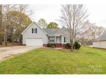 Charming one-story home featuring an attached two-car garage, landscaped front yard, and inviting entrance at 1200 Craig Ave, Lancaster, SC 29720