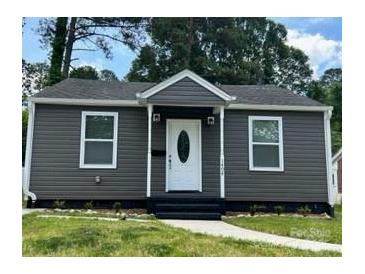 Charming single-story home featuring gray siding and a well-manicured front lawn at 1404 Lineberger Ave, Gastonia, NC 28052