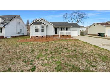 Charming single Gathering home featuring a cozy front porch and manicured lawn at 3632 Farm Lake Sw Dr, Concord, NC 28027