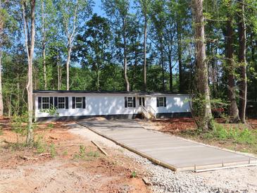 Charming single-story home with newly installed driveway, surrounded by mature trees at 635 Acre Ct, York, SC 29745