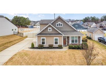 Charming single-Gathering home with a well-manicured lawn and a cozy, inviting front porch at 7413 Adirondack Dr, Denver, NC 28037