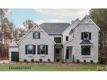 Charming two-story stone home with black shutters and well-manicured front lawn at 8328 Victoria Lake Dr, Waxhaw, NC 28173
