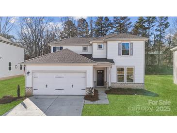 Charming two-story home featuring a two car garage and inviting front yard at 9928 Manor Vista Trl, Kannapolis, NC 28027