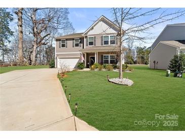 Charming two-story home featuring a well-manicured lawn and inviting curb appeal in a desirable neighborhood at 1036 Bramcote Ln, Charlotte, NC 28215