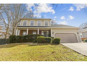 Charming two-story home with a well-manicured lawn and a covered front porch, inviting you to relax and enjoy the outdoors at 11834 Mallard Ridge Dr, Charlotte, NC 28269