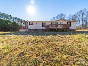 Inviting single-story home featuring a charming front porch and well-maintained landscaping at 137 Beaverbrook Rd, Statesville, NC 28677