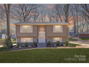 Charming split-level home featuring a well-manicured lawn, complemented by the house's warm exterior and inviting front entrance at 4836 Cheviot Rd, Charlotte, NC 28269