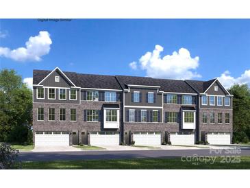 Stylish townhome exterior featuring stone accents, attached garages, and attractive architectural details at 5040 Grain Orchard Rd # 3024C, Indian Trail, NC 28079