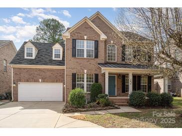 Charming brick home with a well-manicured lawn and inviting front porch at 5672 Wrenfield Ct, Charlotte, NC 28277