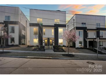 Modern townhome exterior featuring striking architectural design and inviting curb appeal, well-manicured landscaping at 904 Van Every St, Charlotte, NC 28205