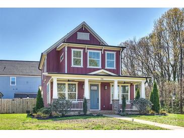 Charming two-story home with a welcoming front porch and beautiful landscaping at 106 Orange St, Charlotte, NC 28205