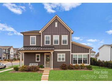 Charming two-story home with a well-manicured lawn, a covered porch, and attractive curb appeal at 12202 Anne Blount Aly, Davidson, NC 28036