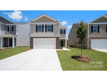 Charming two-story home with a two-car garage, stone accents, and a well-manicured lawn at 1346 37Th Avenue Ne Ln, Hickory, NC 28601