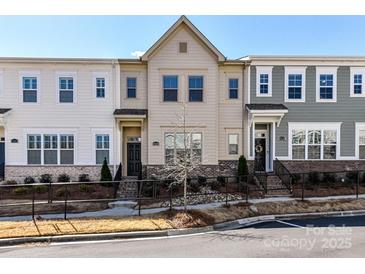 Charming townhome featuring a landscaped front yard and classic architectural details at 15140 Rocky Bluff Loop, Davidson, NC 28036