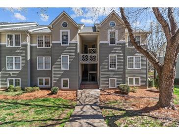Charming condo with a well-maintained exterior, landscaped grounds, and inviting entrance at 19827 Henderson Rd # L, Cornelius, NC 28031