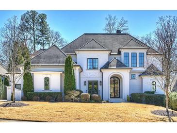 Stunning white brick home featuring a symmetrical design and a well-manicured front lawn at 4018 St Germaine Ln, Charlotte, NC 28210