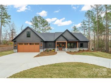Stunning exterior of a modern home with a large driveway, two-car garage, and beautiful landscaping at 4890 Rio De Luna None, Hickory, NC 28601