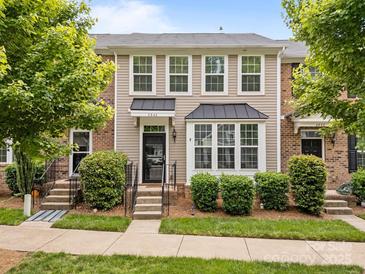 Charming townhome featuring a well-maintained lawn and neutral siding, enhanced by lush landscaping at 6846 Colonial Garden Dr, Huntersville, NC 28078