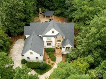 Aerial view of the home, landscaped yard and patio with outdoor fireplace and bar at 1025 Seminole Dr, Waxhaw, NC 28173