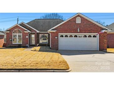 Charming brick home with a well-maintained lawn and attached two-car garage at 1911 Connemara Ct, Gastonia, NC 28054