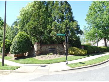 Well-maintained community entrance with stone signage and mature landscaping, providing a welcoming atmosphere at 5963 Pale Moss Ln, Charlotte, NC 28269