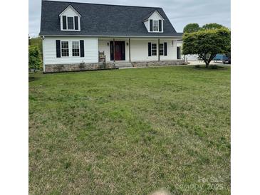 Charming home featuring dormers, a covered porch, and a well-manicured front lawn at 730 Jackson Rd, Salisbury, NC 28146