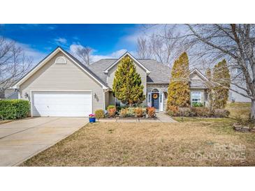Charming home featuring vinyl siding, a two-car garage, and a professionally landscaped front yard at 108 Vermillion Loop, Statesville, NC 28625