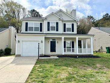 Two-story home with black shutters, front porch and a well maintained lawn at 12044 Brownestone View Dr, Charlotte, NC 28269