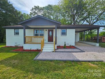 Charming home featuring a quaint front porch and a convenient carport, with a well-manicured lawn at 126 Lowry St, Chester, SC 29706