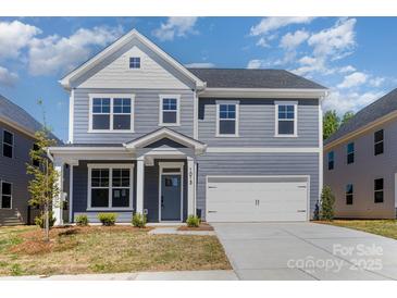 Charming two-story home featuring a covered entryway and attached two-car garage at 1803 Country Club Rd, Lincolnton, NC 28092