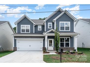 Charming two-story home features a well-manicured lawn, inviting curb appeal, and a classic architectural style at 1809 Country Club Rd, Lincolnton, NC 10757