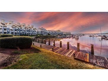 Picturesque dock and marina view with waterfront condos, boats and sunset background at 18861 Vineyard Point Ln, Cornelius, NC 28031
