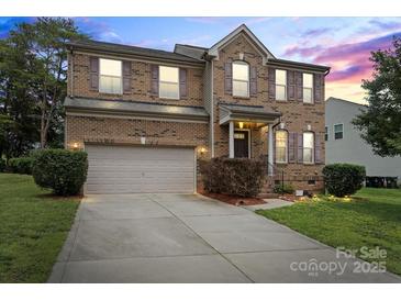 Charming two-story brick home with attached garage, landscaped yard and inviting front entrance at 2177 Galloway Sw Ln, Concord, NC 28025