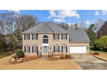 Lovely brick home featuring a two-car garage, manicured lawn, and a welcoming entrance at 8606 Chatsworth Ln, Waxhaw, NC 28173