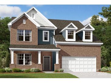Charming two-story brick home with a covered front porch, attached two-car garage, and beautifully landscaped front yard at 11105 Lochmere Rd, Charlotte, NC 28278