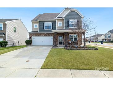 Charming two-story home with landscaped yard, covered porch, and two car garage at 14815 Superior St, Charlotte, NC 28273
