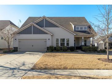 Charming single-Gathering home featuring a two-car garage, well-manicured lawn, and inviting curb appeal at 15035 Batteliere Dr, Charlotte, NC 28278