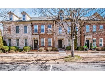 Charming brick townhomes offer curb appeal with landscaped front yards and inviting entrances at 19915 Lamp Lighters Way, Cornelius, NC 28031