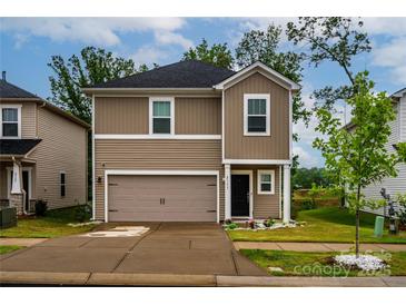 Charming two-story home with a welcoming front porch, well manicured lawn, and attached garage in a nice community at 2131 Belterra Dr, Charlotte, NC 28216